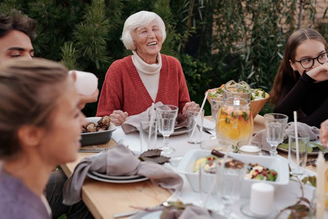 An image of a simple picknick outside with elderly friends and family