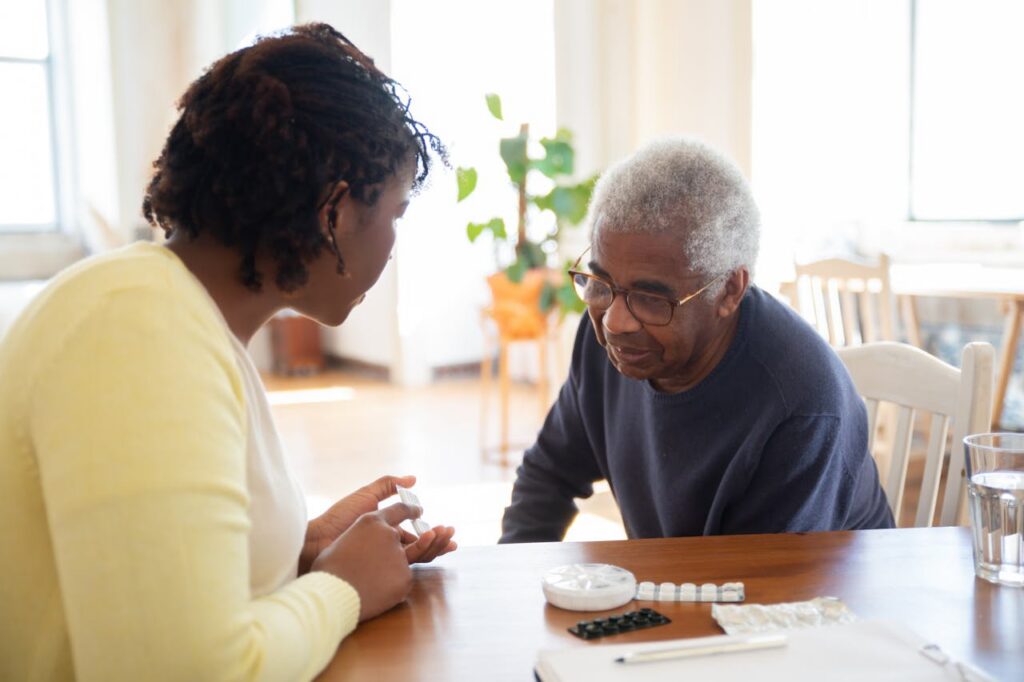 A care personnel helping an elderly person