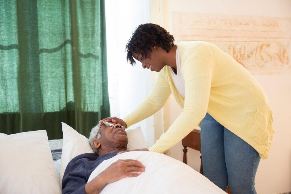 An image of a carer putting an elderly person to sleep