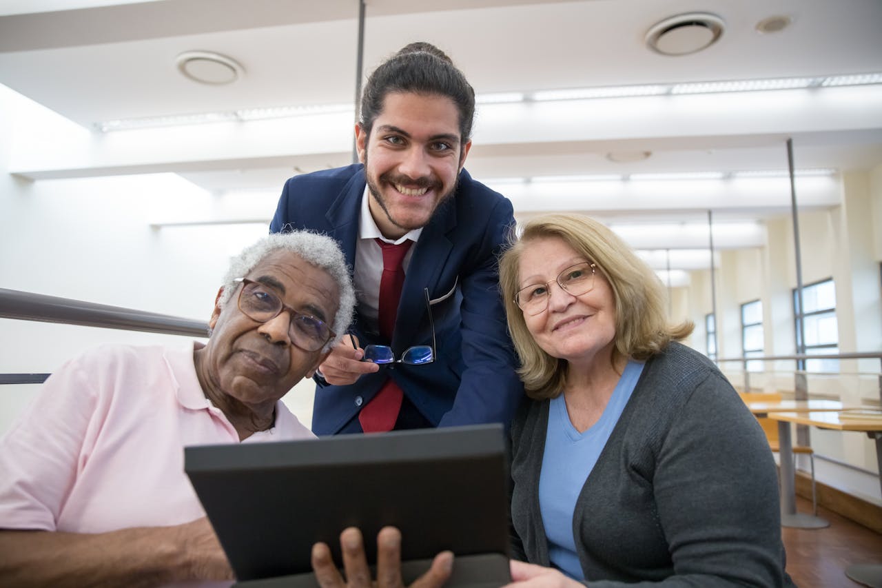 A care expert showcasing an event to an elderly couple